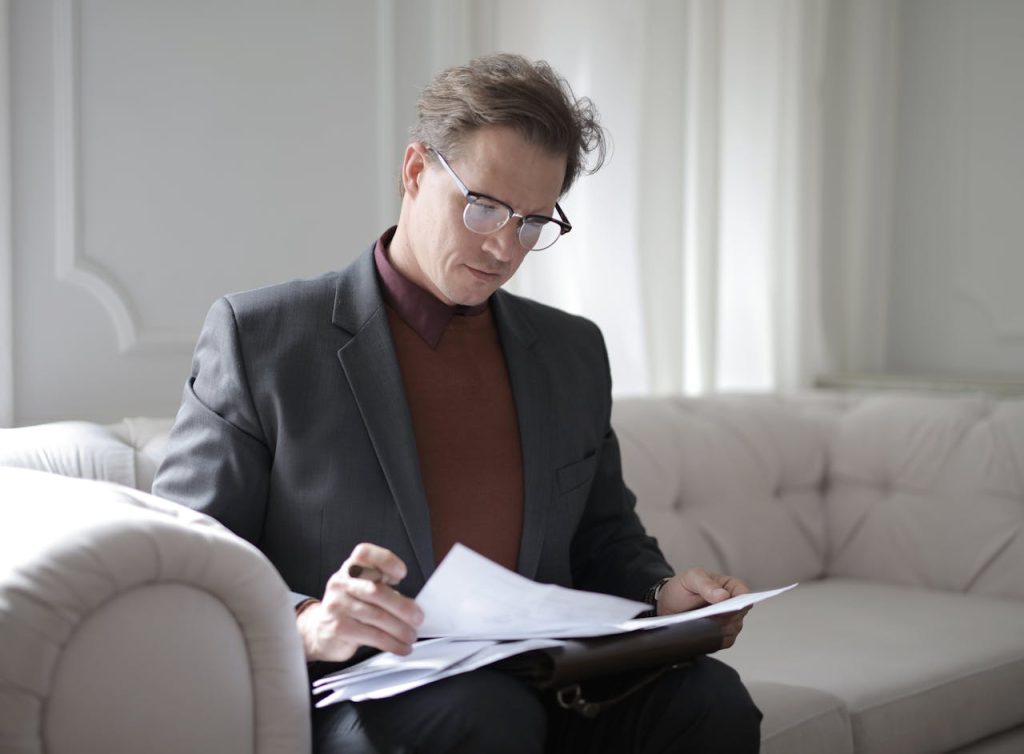 man reading papers